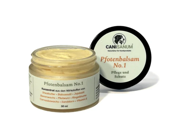 Canisanum® Pfotenbalsam No. 1, geöffneter Tiegel mit hellgelbem Balsam, der Deckel daneben